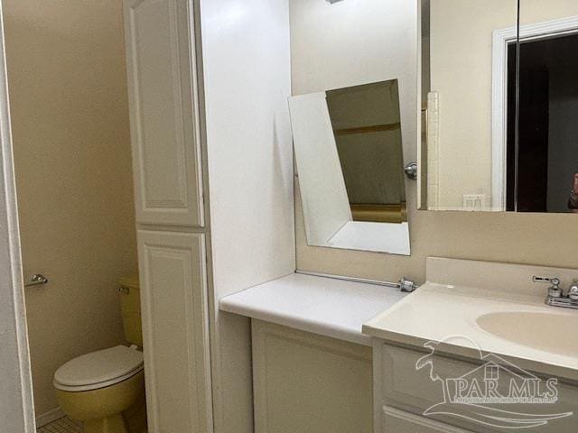 bathroom with toilet and vanity