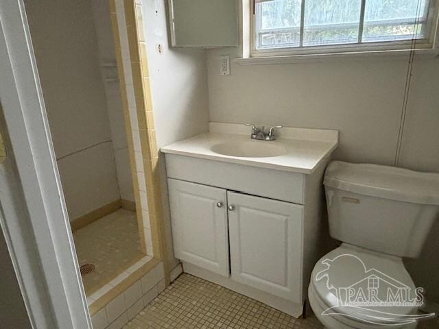 bathroom featuring walk in shower, vanity, and toilet