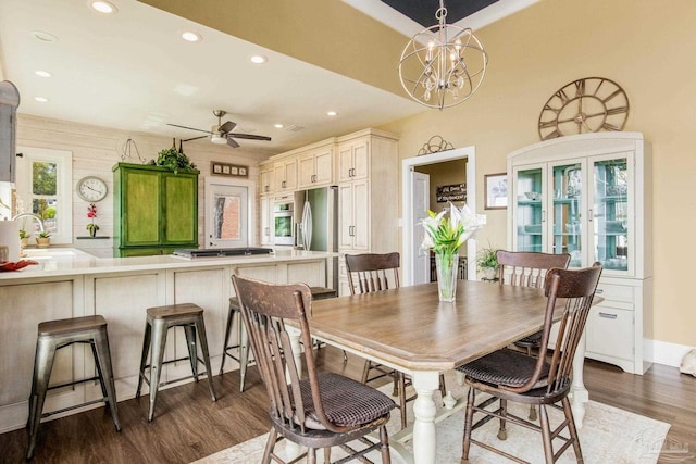 dining area with dark wood-style floors, recessed lighting, and ceiling fan with notable chandelier