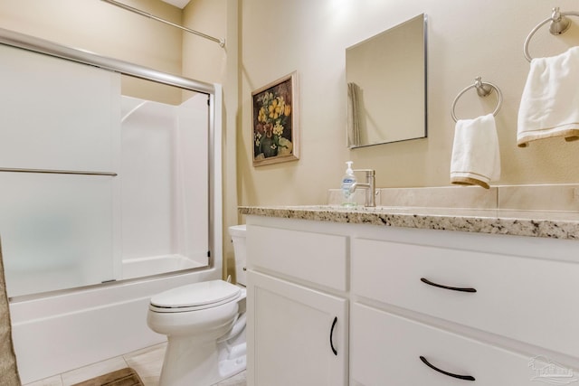 full bathroom featuring toilet, shower / bath combination with glass door, tile patterned floors, and vanity