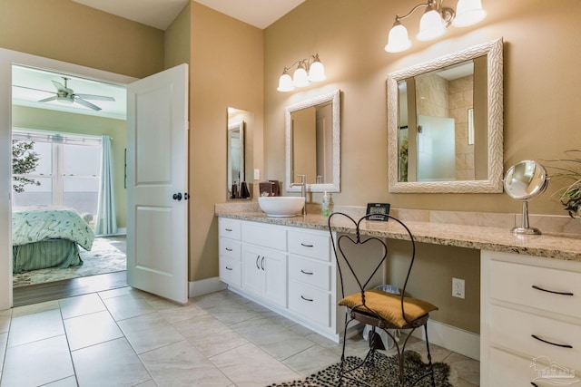 ensuite bathroom with a ceiling fan, connected bathroom, vanity, tiled shower, and baseboards