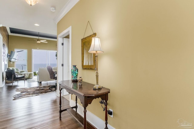 hall with hardwood / wood-style flooring and ornamental molding