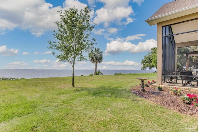 view of yard featuring a patio area and a water view