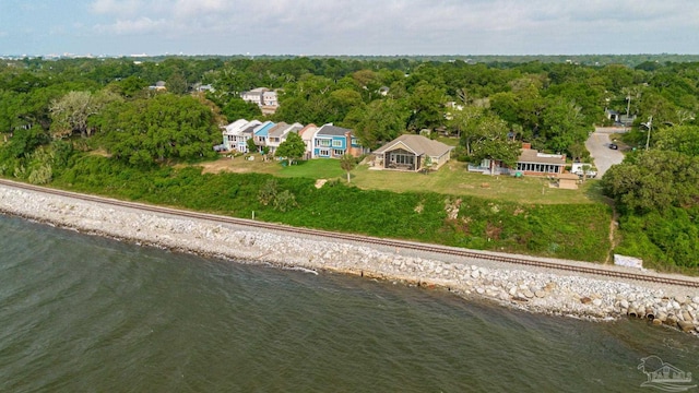 aerial view with a water view and a wooded view