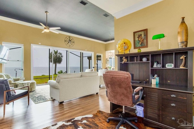 office featuring ornamental molding, a ceiling fan, visible vents, and wood finished floors