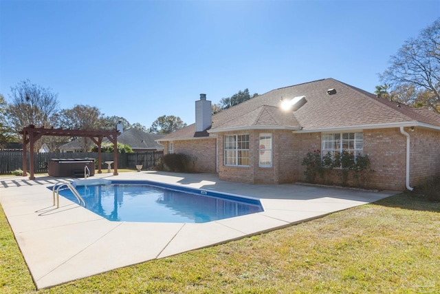 view of swimming pool featuring a yard, a pergola, a hot tub, and a patio area