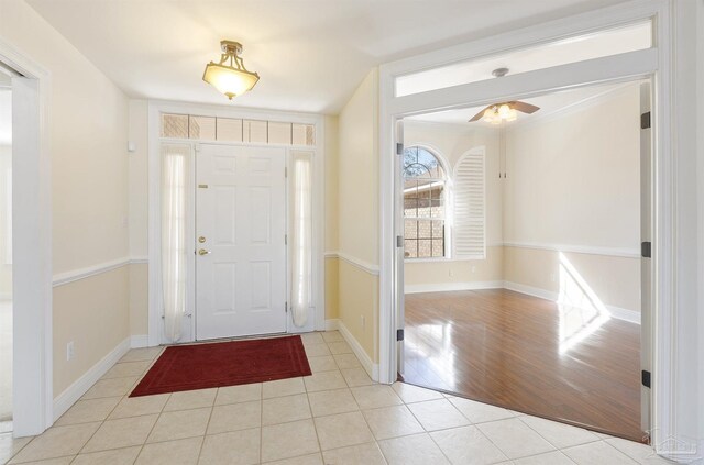 foyer featuring light wood-type flooring and ceiling fan