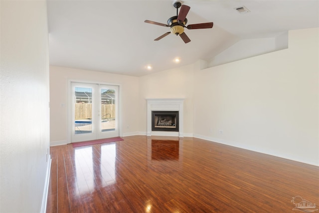 unfurnished living room with ceiling fan, wood-type flooring, and vaulted ceiling