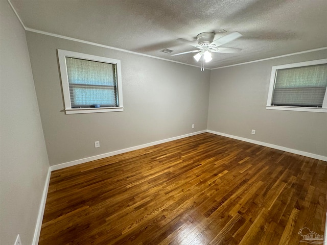 unfurnished room with a textured ceiling, ornamental molding, dark wood-type flooring, and ceiling fan