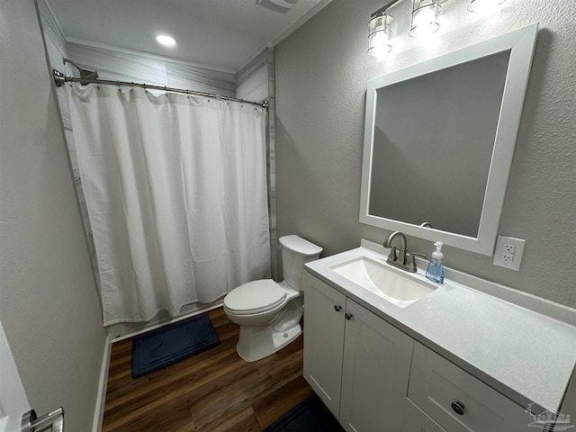 bathroom featuring walk in shower, vanity, hardwood / wood-style floors, and toilet