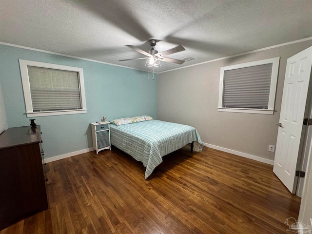 bedroom with ceiling fan, ornamental molding, a textured ceiling, and dark hardwood / wood-style flooring