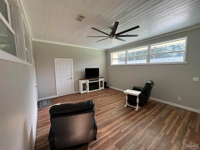 sitting room with crown molding, wood ceiling, dark wood-type flooring, and ceiling fan