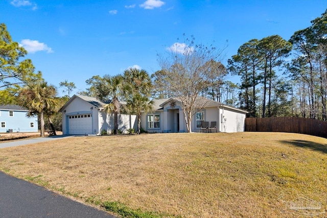 ranch-style house featuring a garage and a front lawn