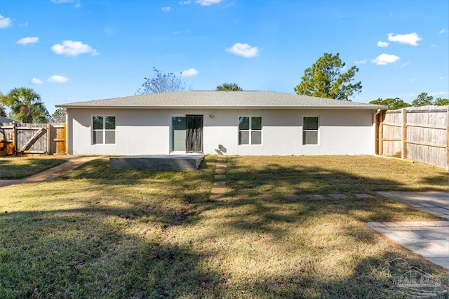 back of house featuring a patio and a yard