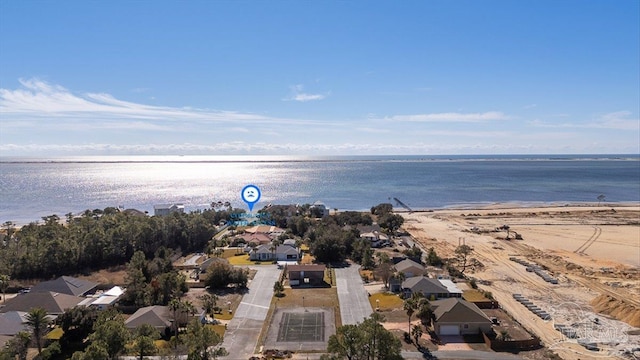 birds eye view of property with a water view and a beach view