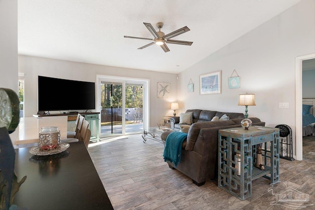 living room featuring lofted ceiling and ceiling fan