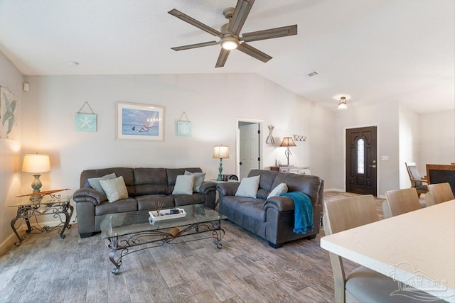 living room with wood-type flooring, vaulted ceiling, and ceiling fan