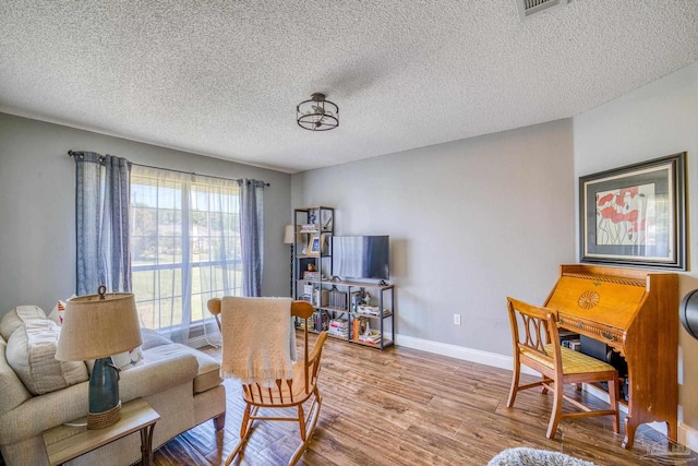 interior space featuring a textured ceiling and hardwood / wood-style flooring