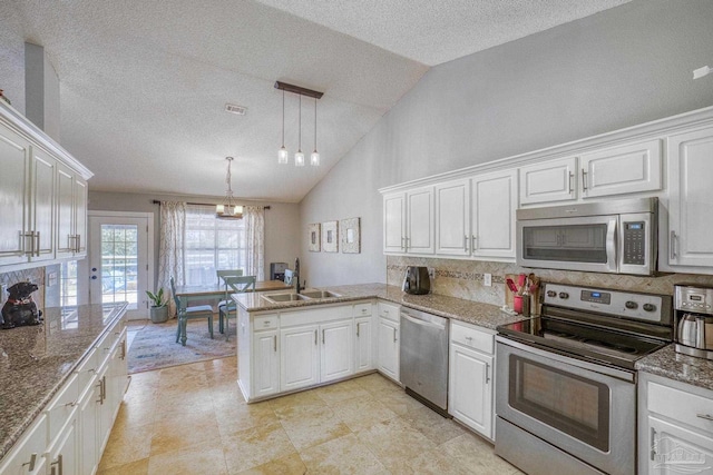 kitchen with stainless steel appliances, white cabinets, kitchen peninsula, and sink