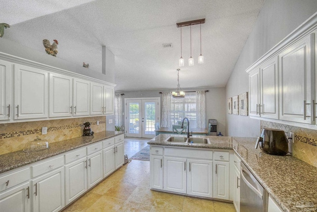 kitchen with white cabinetry, backsplash, french doors, and sink