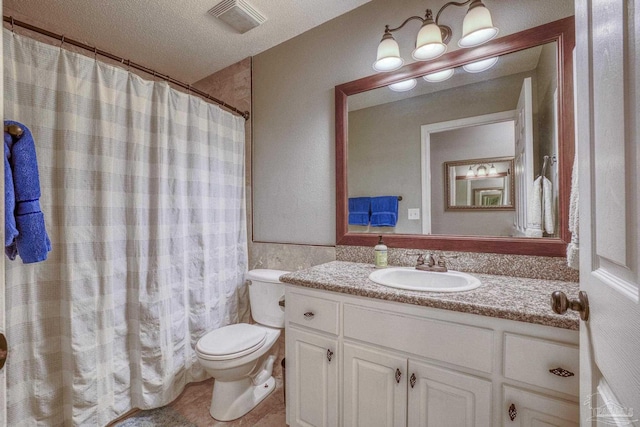 bathroom featuring a textured ceiling, vanity, tile walls, toilet, and walk in shower