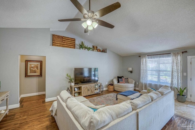 living room featuring vaulted ceiling, ceiling fan, and hardwood / wood-style flooring