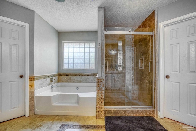 bathroom featuring tile walls, plus walk in shower, and a textured ceiling