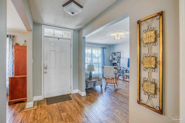 entryway featuring a textured ceiling and hardwood / wood-style floors