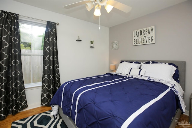 bedroom with ceiling fan and hardwood / wood-style floors