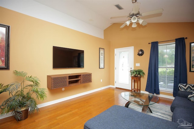 living room with ceiling fan, wood-type flooring, and vaulted ceiling