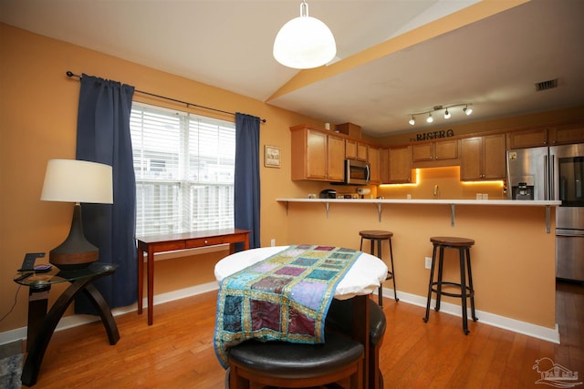 dining area with sink and light wood-type flooring