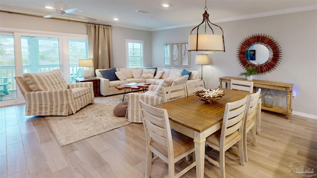 dining space with visible vents, light wood-style flooring, ornamental molding, recessed lighting, and baseboards