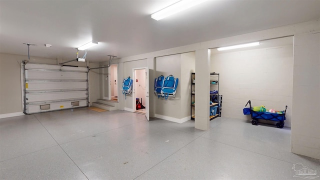 garage with concrete block wall and a garage door opener