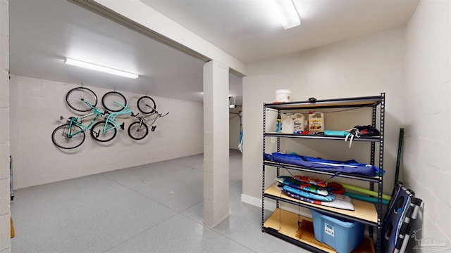 finished basement featuring concrete block wall