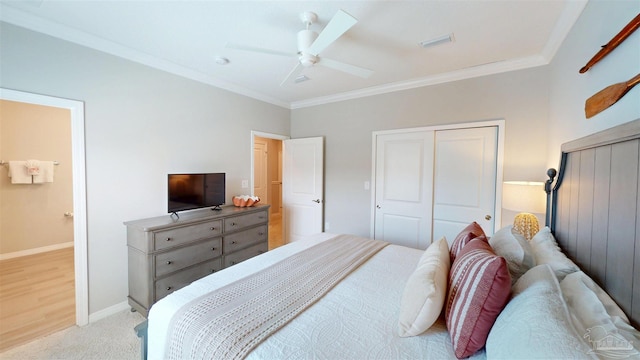 bedroom with visible vents, crown molding, baseboards, light colored carpet, and ceiling fan