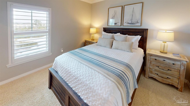 bedroom with baseboards and light carpet