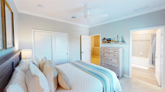 bedroom with crown molding, light colored carpet, a closet, and ceiling fan