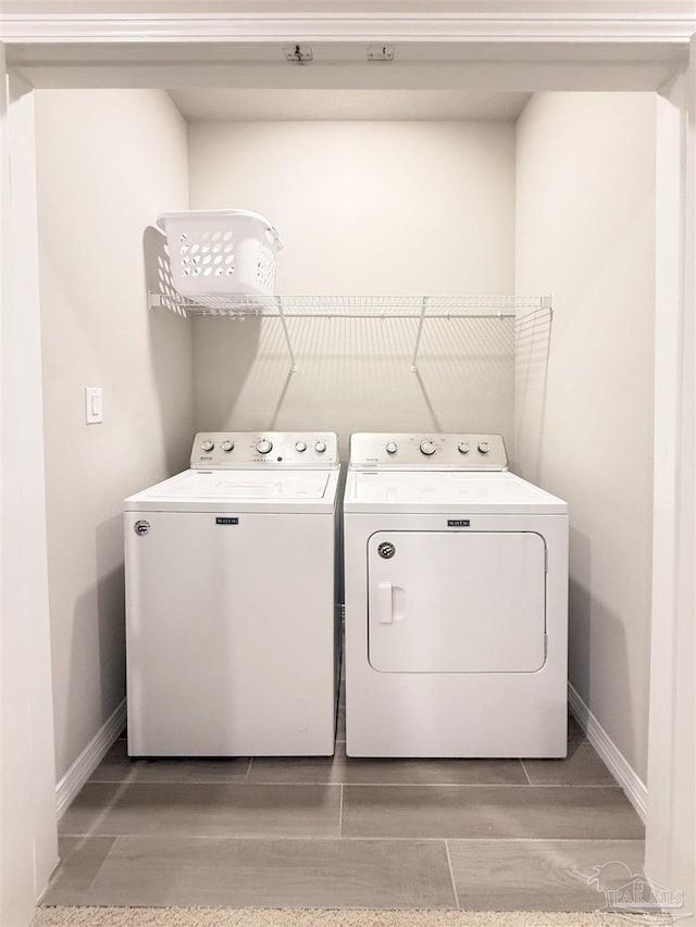 laundry room with laundry area, baseboards, and washing machine and clothes dryer