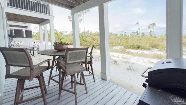 deck with outdoor dining area and a grill