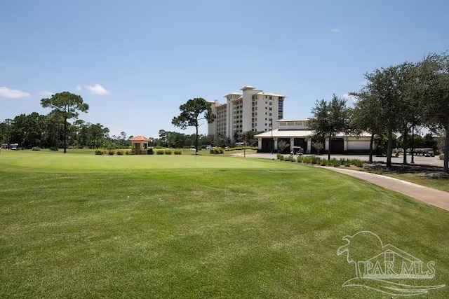 view of home's community featuring a lawn and view of golf course