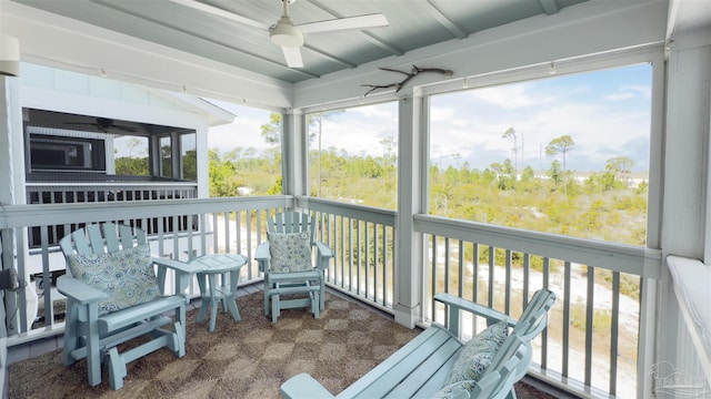 sunroom / solarium with a ceiling fan