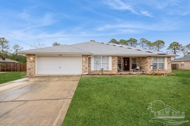 ranch-style house featuring a garage and a front lawn