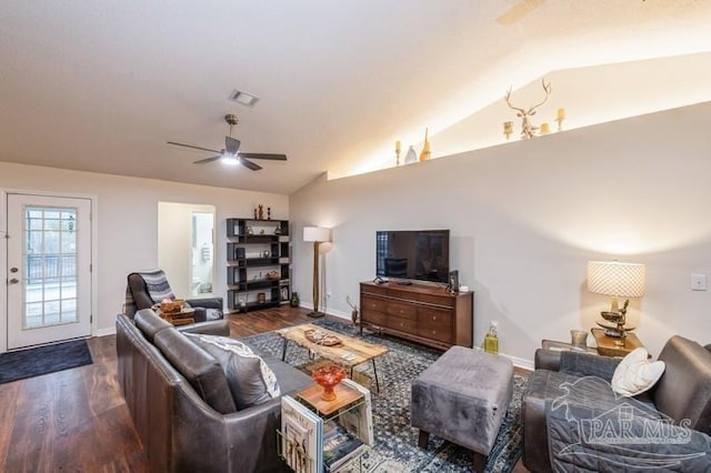 living room featuring ceiling fan, lofted ceiling, and dark hardwood / wood-style flooring