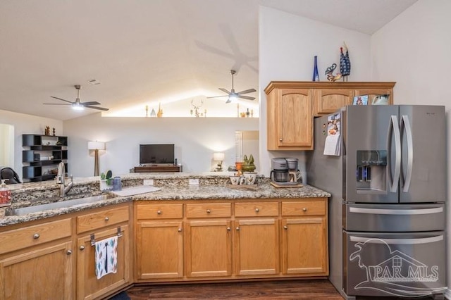 kitchen with sink, light stone countertops, ceiling fan, and stainless steel refrigerator with ice dispenser