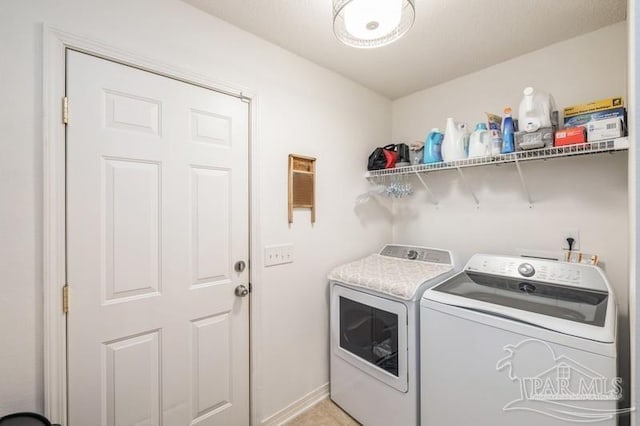 laundry area with washing machine and dryer