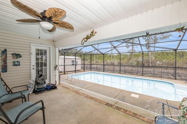 view of swimming pool featuring a patio, ceiling fan, and a storage unit