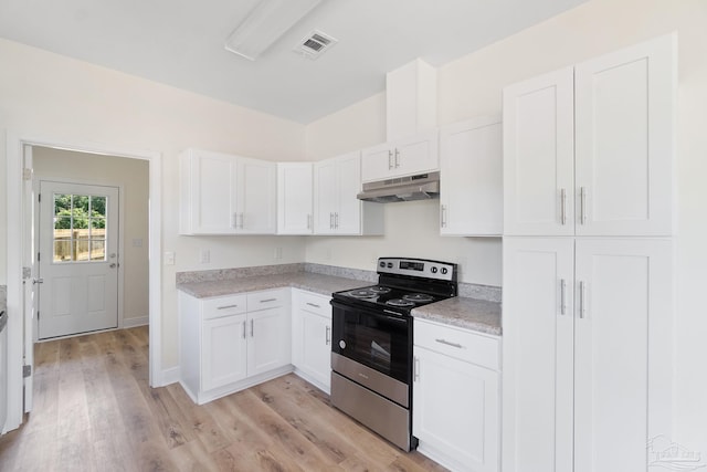 kitchen with light countertops, visible vents, electric range, white cabinetry, and under cabinet range hood