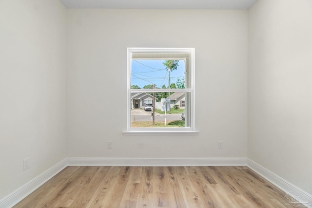 spare room with light wood finished floors and baseboards