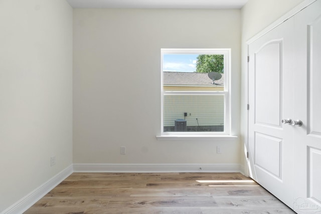 interior space featuring light wood-style flooring and baseboards