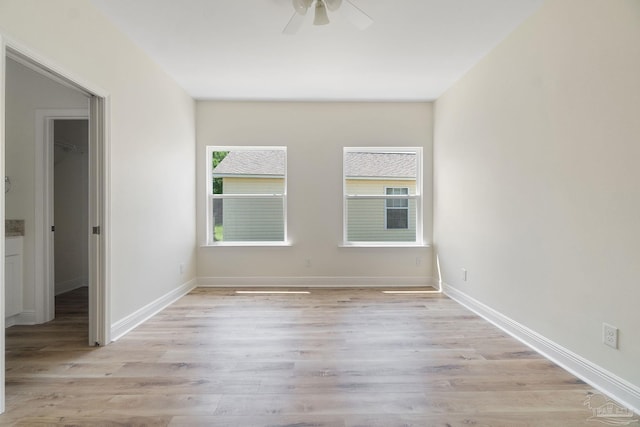 spare room featuring a ceiling fan, baseboards, and wood finished floors